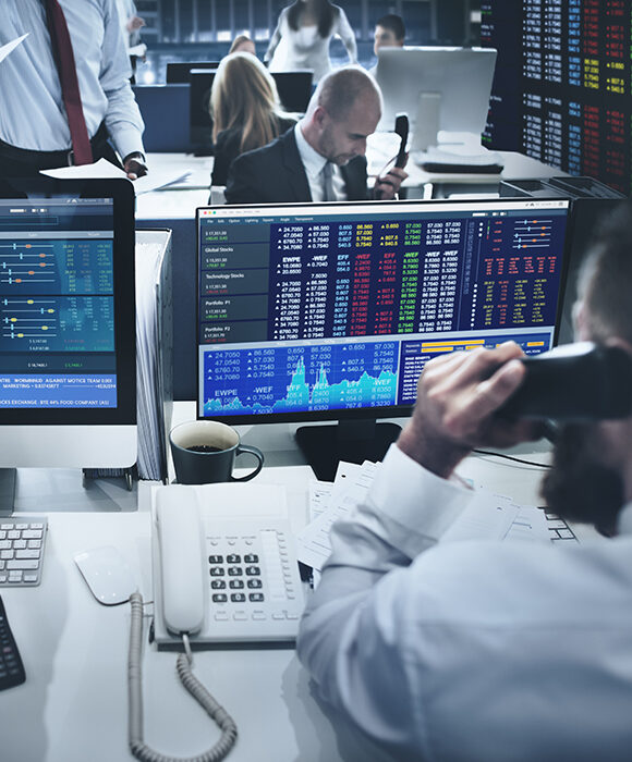 Traders on a trading floor working in front of their monitors