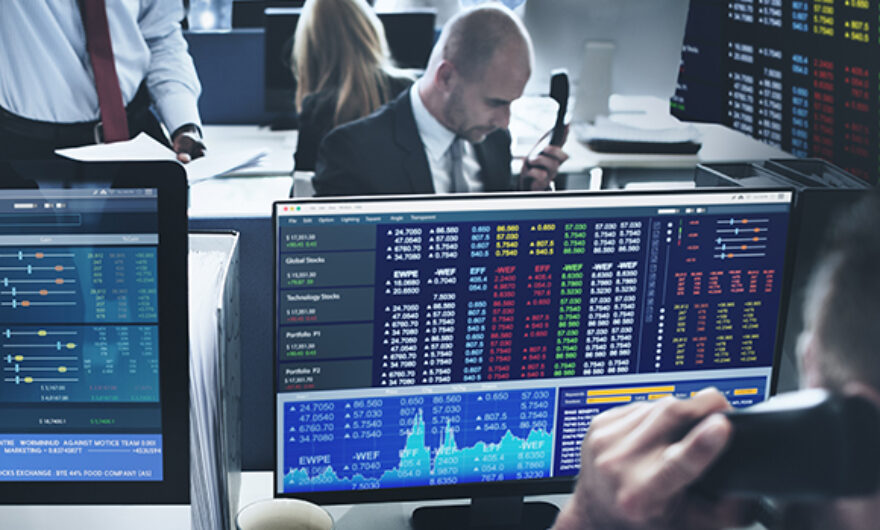 Traders on a trading floor working in front of their monitors
